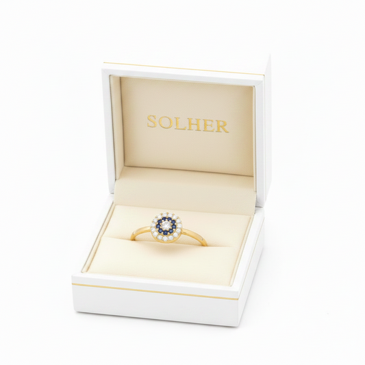 Anillo  círculo en 100%  Oro de 18 Kl. con circonitas y crisopal azul.