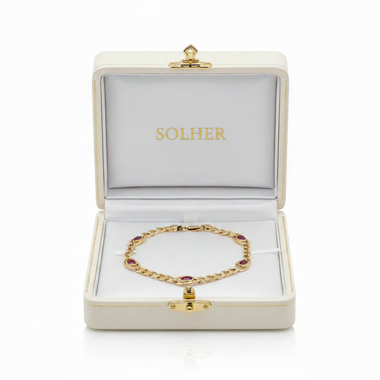 Pulsera REBECA 100% en oro de 18 Kl. con piedras en color rojo.